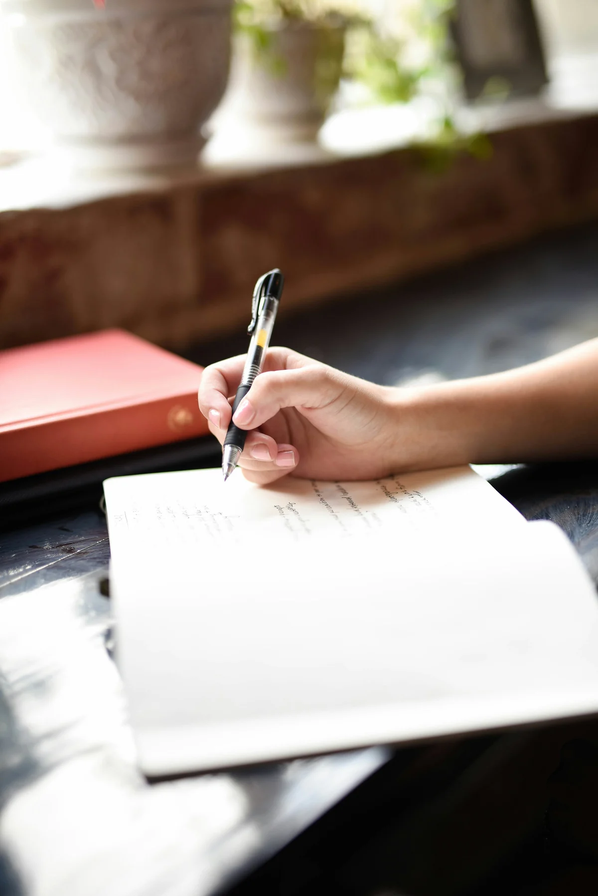Hand schreibt in ein Lerntagebuch